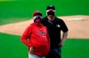 Los Angeles Angels manager Joe Maddon, left, looks up alongside second base umpire Bill Miller as they wait for lights to be turned on at Petco Park during the first inning of a baseball game against the San Diego Padres, Tuesday, Sept. 22, 2020, in San Diego. (AP Photo/Gregory Bull)