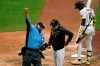 Umpire Tom Hallion, left, ejects San Diego Padres manager Jayce Tingler, center, as San Diego Padres' Jurickson Profar waits to bat during the eighth inning of a baseball game against the Milwaukee Brewers Wednesday, April 21, 2021, in San Diego. (AP Photo/Gregory Bull)