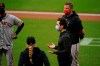 San Francisco Giants general manager Scott Harris, second from right, speaks to members of the team after their baseball game against the San Diego Padres was postponed Friday, Sept. 11, 2020, in San Diego. The game was postponed minutes before the scheduled first pitch after someone in the Giants organization tested positive for COVID-19. (AP Photo/Gregory Bull)