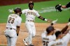 San Diego Padres' Jurickson Profar, second from left, celebrates after scoring off a three-RBI double by Eric Hosmer during the seventh inning of a baseball game against the Arizona Diamondbacks, Friday, July 24, 2020, in San Diego. (AP Photo/Gregory Bull)