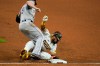 San Diego Padres' Fernando Tatis Jr., below, collides with Colorado Rockies first baseman Daniel Murphy while unable to get back to first on a line-out by Manny Machado during the seventh inning of a baseball game Monday, Sept. 7, 2020, in San Diego. (AP Photo/Gregory Bull)