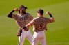 San Diego Padres shortstop Fernando Tatis Jr, left, and second baseman Jake Cronenworth (9) celebrate after they defeated the Los Angeles Dodgers in a baseball game Sunday, April 18, 2021, in San Diego. (AP Photo/Gregory Bull)