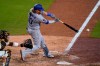 Los Angeles Dodgers' Justin Turner hits an RBI single during the ninth inning of the team's baseball game against the San Diego Padres, Friday, April 16, 2021, in San Diego. (AP Photo/Gregory Bull)