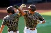 San Diego Padres' Manny Machado, right, reacts with teammate Eric Hosmer after hitting a home run during the first inning of a baseball game against the Seattle Mariners, Thursday, Aug. 27, 2020, in San Diego. (AP Photo/Gregory Bull)