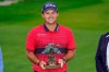 Patrick Reed stands on the South Course while holding his trophy for winning the Farmers Insurance Open golf tournament at Torrey Pines, Sunday, Jan. 31, 2021, in San Diego. (AP Photo/Gregory Bull)