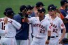 Houston Astros manager Dusty Baker Jr., left, celebrates with Michael Brantley (23), Josh Reddick (22) and others after the Astros defeated the Oakland Athletics in Game 4 of a baseball American League Division Series in Los Angeles, Thursday, Oct. 8, 2020. (AP Photo/Ashley Landis)