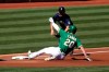 Oakland Athletics' Mark Canha (20) slides safely into third as Seattle Mariners' Kyle Seager applies the tag during the first inning of the first baseball game of a doubleheader in Oakland, Calif., Saturday, Sept. 26, 2020. (AP Photo/Jed Jacobsohn)
