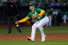 Oakland Athletics third baseman Matt Chapman can't field a single hit by Los Angeles Dodgers' Austin Barnes during the fourth inning of a baseball game in Oakland, Calif., Tuesday, April 6, 2021. (AP Photo/Jed Jacobsohn)