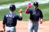 Tampa Bay Rays' Mike Brosseau, right, is congratulated by teammate Joey Wendle after hitting a solo home run against the Oakland Athletics during the sixth inning of a baseball game in Oakland, Calif., Sunday, May 9, 2021. (AP Photo/Jed Jacobsohn)