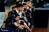 New York Yankees players watch from the dugout as they trail the Tampa Bay Rays during the ninth inning in Game 3 of a baseball American League Division Series, Wednesday, Oct. 7, 2020, in San Diego. (AP Photo/Gregory Bull)