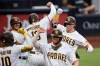 San Diego Padres' Jake Cronenworth, back right, celebrates his grand slam with Manny Machado during the second inning of the team's baseball game against the Houston Astros in San Diego, Saturday, Aug. 22, 2020. (AP Photo/Kelvin Kuo)