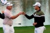 Si Woo Kim, right, bumps fists with Ted Potter Jr. after they finished the second round of The American Express golf tournament on the Nicklaus Tournament Course at PGA West, Friday, Jan. 22, 2021, in La Quinta, Calif. (AP Photo/Marcio Jose Sanchez)