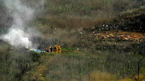 Firefighters work the scene of a helicopter crash where former NBA star Kobe Bryant died, Sunday, Jan. 26, 2020, in Calabasas, Calif. (AP Photo/Mark J. Terrill)