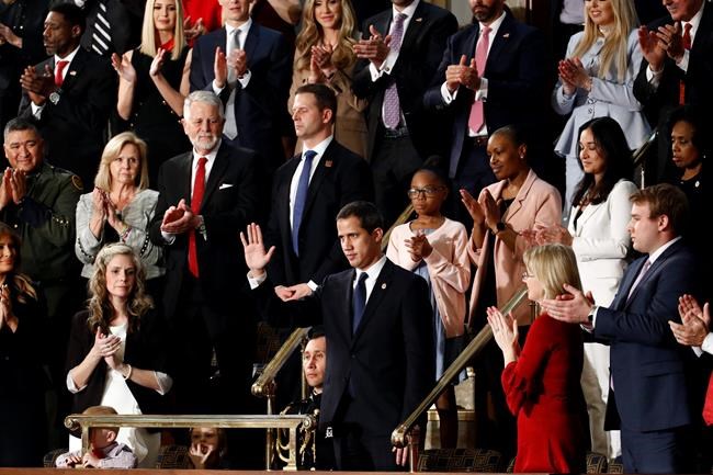 Venezuelan opposition leader Juan Guaido waves as President Donald Trump delivers his State of the Union address to a joint session of Congress on Capitol Hill in Washington, Tuesday, Feb. 4, 2020. (AP Photo/Patrick Semansky)