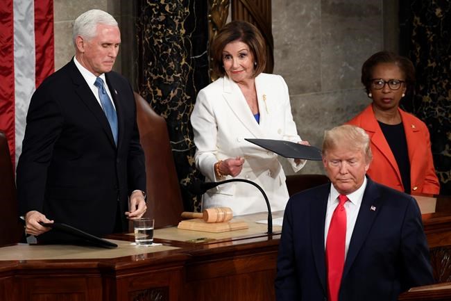 President Donald Trump turns after handing copies of his speech to House Speaker Nancy Pelosi of Calif., and Vice President Mike Pence as he delivers his State of the Union address to a joint session of Congress on Capitol Hill in Washington, Tuesday, Feb. 4, 2020. (AP Photo/Susan Walsh)