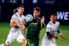 Portland Timbers forward Felipe Mora, center, controls the ball near two LA Galaxy players, including Sacha Kljestan, left, during the first half of an MLS soccer match in Carson, Calif., Wednesday, Oct. 7, 2020. (AP Photo/Ringo H.W. Chiu)