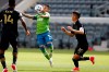 Seattle Sounders midfielder Raul Ruidiaz (9) controls the ball between Los Angeles FC midfielders Mark-Anthony Kaye (14) and Eduard Atuesta (20) during the first half of an MLS soccer match, Saturday, April 24, 2021, in Los Angeles. (AP Photo/Ringo H.W. Chiu)