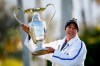 Patty Tavatanakit, of Thailand, smiles while holding the trophy after winning the LPGA's ANA Inspiration golf tournament at Mission Hills Country Club on Sunday, April 4, 2021, in Rancho Mirage, Calif. (AP Photo/Ringo H.W. Chiu)