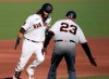 San Francisco Giants' Brandon Crawford, left, is congratulated by third base coach Ron Wotus as he runs the bases after hitting a solo home run against the San Diego Padres during the second inning of the first game of a baseball doubleheader Friday, Sept. 25, 2020, in San Francisco. (AP Photo/Tony Avelar)