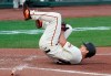 San Francisco Giants' Alex Dickerson reacts after getting hit by a ball that bounced off his bat during the fifth inning of a baseball game against the Arizona Diamondbacks, Monday, Sept. 7, 2020, in San Francisco. (AP Photo/Tony Avelar)