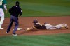 San Diego Padres' Fernando Tatis Jr., right, slides into second base on a double that scored two runs against the Oakland Athletics during the fifth inning of a baseball game in Oakland, Calif., Friday, Sept. 4, 2020. (AP Photo/Tony Avelar)
