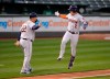 Houston Astros' Alex Bregman (2) celebrates with third base coach Omar Lopez (22) as he runs the bases after hitting a three-run home run against the Oakland Athletics during the third inning of a baseball game Friday, April 2, 2021, in Oakland, Calif. (AP Photo/Tony Avelar)