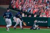 Seattle Mariners first baseman Evan White, right, dives for but can't make the catch on a double by San Francisco Giants' Wilmer Flores, as right fielder Phillip Ervin, center, and second baseman Ty France (23) come to assist during the fourth inning of a baseball game Wednesday, Sept. 9, 2020, in San Francisco. (AP Photo/Tony Avelar)