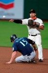 San Francisco Giants shortstop Donovan Solano throws to first to complete the double play on Seattle Mariners' Ty France after getting the force on Kyle Seager during the fifth inning of a baseball game Tuesday, Sept. 8, 2020, in San Francisco. (AP Photo/Tony Avelar)