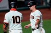 San Francisco Giants' Alex Dickerson, right, is congratulated by Evan Longoria (10) after scoring on a sacrifice fly by Brandon Crawford during the fifth inning against the Colorado Rockies in a baseball game Wednesday, Sept. 23, 2020, in San Francisco. (AP Photo/Tony Avelar)