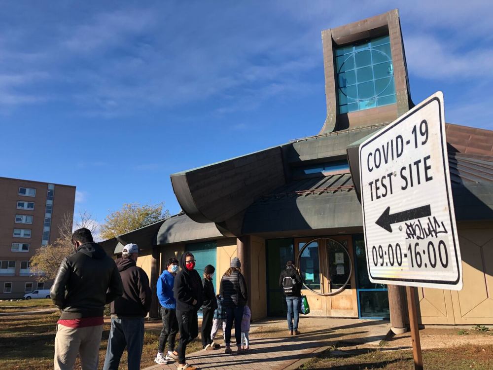 People line up outside the Thunderbird House COVID-19 test site in Winnipeg in October 2020. While official reporting numbers, based on PCR testing, say only about five per cent of the provincial population has contracted COVID-19 since Dec. 1, a Toronto infectious disease researcher estimates at least half of Manitobans have been infected since then. (Lyzaville Sale/CBC)