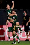 Portland Timbers midfielder Sebastian Blanco, top, celebrates his goal with Diego Valeri against the Philadelphia Union during the second half of an MLS soccer match, Wednesday, Aug. 5, 2020, in Kissimmee, Fla. (AP Photo/John Raoux)