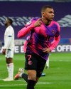 Paris Saint Germain's Kylian Mbappe celebrates after he scored a goal against Lyon during the French League One soccer match between Lyon and PSG in Decines, near Lyon, central France, Sunday, March 21, 2021. (AP Photo/Laurent Cipriani)