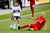 Toronto FC midfielder Michael Bradley (4) slide tackles Vancouver Whitecaps midfielder Ryan Raposo (27) during second half MLS soccer action at BMO field in Toronto, Tuesday, Aug. 18, 2020. THE CANADIAN PRESS/Cole Burston