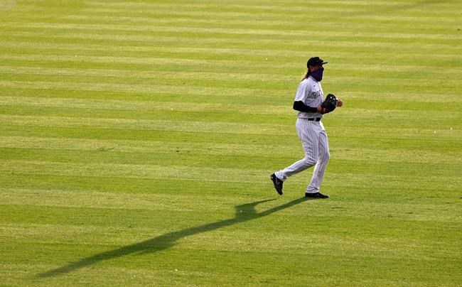 FILE - Colorado Rockies right fielder Charlie Blackmon casts a long shadow as he takes his position in the third inning of a baseball game against the San Diego Padres in this file photograph taken Saturday, Aug. 1, 2020, in Denver. Success doesn't push the ever-thinking, ever-tinkering Charlie Blackmon nearly as much as failure. (AP Photo/David Zalubowski, File)