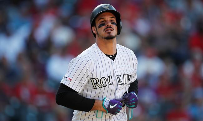 FILE - In this Sept. 12, 2019, file photo, Colorado Rockies' Nolan Arenado reacts after being put out against the St. Louis Cardinals in the eighth inning of a baseball game in Denver. Arenado, the Rockies' top player, is at odds with the team's management as spring training opens for the club. (AP Photo/David Zalubowski, File)