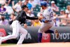 Colorado Rockies third baseman Ryan McMahon, left, tags out Los Angeles Dodgers' Max Muncy on the back end of a double play as he tried to advance from second to third base on a fly ball in the first inning of a baseball game Sunday, April 4, 2021, in Denver. (AP Photo/David Zalubowski)