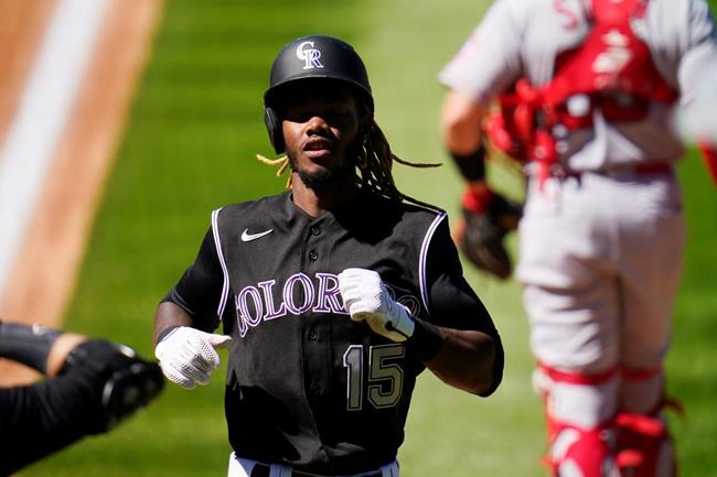 Colorado Rockies' Raimel Tapia socires on a double hit by Kevin Pillar off Los Angeles Angels starting pitcher Andrew Heaney in the third inning of a baseball game Sunday, Sept. 13, 2020, in Denver. (AP Photo/David Zalubowski)