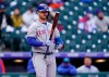 New York Mets' Pete Alonso stares at his bat while facing Colorado Rockies starting pitcher Chi Chi Gonzalez in the first inning in the first baseball game of a doubleheader, Saturday, April 17, 2021, in Denver. (AP Photo/David Zalubowski)