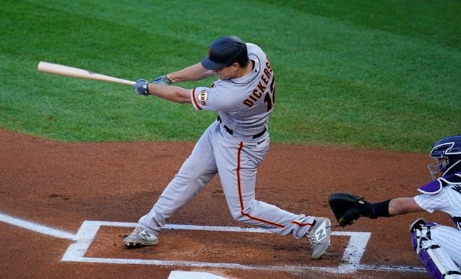 San Francisco Giants' Alex Dickerson connects for a solo home run off Colorado Rockies starting pitcher Jon Gray as catcher Tony Wolters looks for the pitch in the first inning of a baseball game Tuesday, Sept. 1, 2020, in Denver. (AP Photo/David Zalubowski)