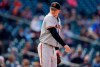 San Francisco Giants starting pitcher Logan Webb reacts after walking Colorado Rockies 'Alan Trejo with the bases loaded during the fourth inning of a baseball game Wednesday, May 5, 2021, in Denver. (AP Photo/David Zalubowski)