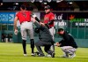 Arizona Diamondbacks' Ketel Marte, left, gets to his feet with help after injuring his leg while running out a ground ball during the sixth inning of the team's baseball game against the Colorado Rockies on Wednesday, April 7, 2021, in Denver. (AP Photo/David Zalubowski)