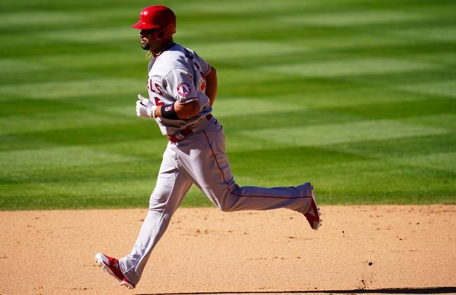 Los Angeles Angels' Albert Pujols circles the bases after hitting a two-run home run off Colorado Rockies relief pitcher Carlos Estevez in the eighth inning of a baseball game Sunday, Sept. 13, 2020, in Denver. (AP Photo/David Zalubowski)