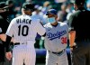 Colorado Rockies manager Bud Black, left, exchanges lineup cards at home plate with Los Angeles Dodgers manager Dave Roberts before the first inning of a baseball game Thursday, April 1, 2021, in Denver. (AP Photo/David Zalubowski)