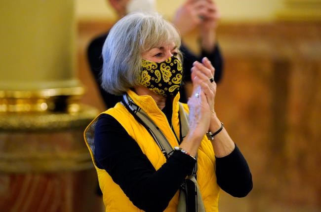 Judi Ingelido of Colorado Springs, Colo., one of Colorado's nine Democratic presidential electors, applauds during the announcement that all electors had cast their ballots for Joe Biden at the State Capitol, Monday, Dec. 14, 2020, in downtown Denver. (AP Photo/David Zalubowski, Pool)