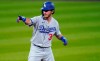 Los Angeles Dodgers' Cody Bellinger gestures to the dugout after pulling into second base with a double off Colorado Rockies relief pitcher Wade Davis to lead off seventh inning of a baseball game Friday, Sept. 18, 2020, in Denver. The Dodgers won 15-6. (AP Photo/David Zalubowski)
