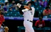 Colorado Rockies' Dom Nunez follows the flight of his three-run home run off Arizona Diamondbacks starting pitcher Merrill Kelly in the sixth inning of a baseball game Thursday, April 8, 2021, in Denver. (AP Photo/David Zalubowski)