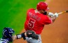Los Angeles Angels' Albert Pujols, right, connects for a single as Colorado Rockies catcher Tony Wolters looks for the pitch in the fourth inning of a baseball game Saturday, Sept. 12, 2020, in Denver. (AP Photo/David Zalubowski)