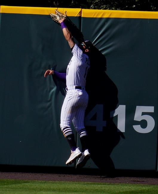 Colorado Rockies center fielder Kevin Pillar runs into the wall as he pulls in a fly ball off the bat of San Francisco Giants' Evan Longoria for the third out in the top of the seventh inning of a baseball game Wednesday, Sept. 2, 2020, in Denver. (AP Photo/David Zalubowski)