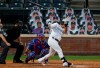 Colorado Rockies' Tony Wolters, right, loses his bat while swinging at a pitch as Texas Rangers catcher Jose Trevino, center, and the home plate umpire look on in the fourth inning of a baseball game Saturday, Aug. 15, 2020, in Denver. (AP Photo/David Zalubowski)