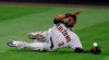 Arizona Diamondbacks center fielder Starling Marte tries to catch a ball hit by Colorado Rockies' Raimel Tapia that fell in for a two-run double during the eighth inning of a baseball game Tuesday, Aug. 11, 2020, in Denver. The Rockies won 8-7. (AP Photo/David Zalubowski)